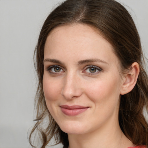 Joyful white young-adult female with long  brown hair and grey eyes