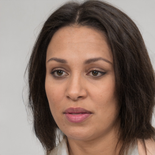 Joyful white adult female with long  brown hair and brown eyes