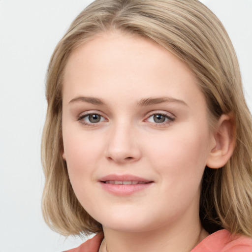 Joyful white young-adult female with long  brown hair and blue eyes