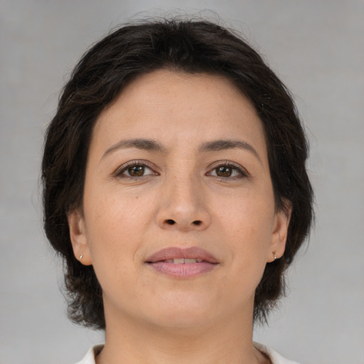 Joyful asian adult female with medium  brown hair and brown eyes