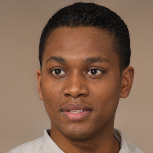 Joyful black young-adult male with short  black hair and brown eyes