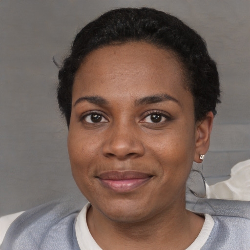 Joyful black adult female with short  black hair and brown eyes