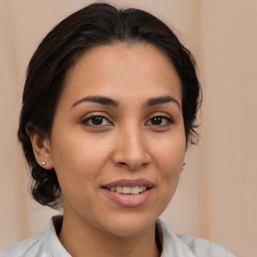 Joyful latino young-adult female with medium  brown hair and brown eyes