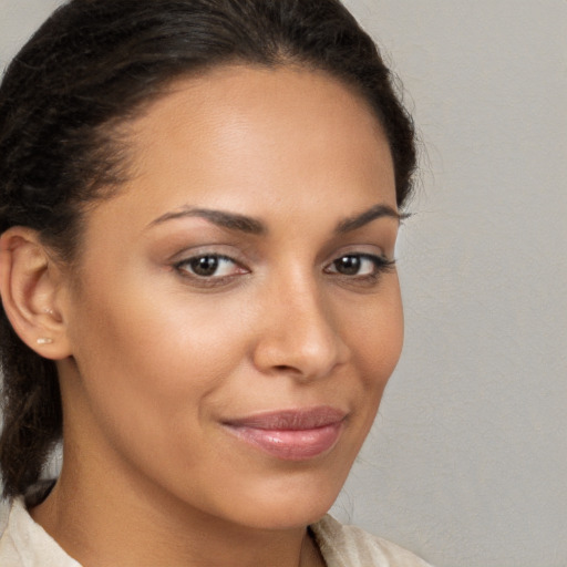 Joyful latino young-adult female with medium  brown hair and brown eyes