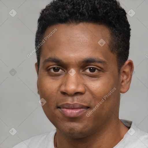 Joyful black young-adult male with short  black hair and brown eyes