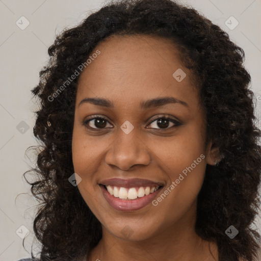 Joyful black young-adult female with long  brown hair and brown eyes