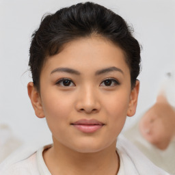 Joyful asian young-adult female with short  brown hair and brown eyes