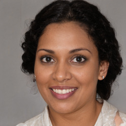 Joyful black young-adult female with medium  brown hair and brown eyes