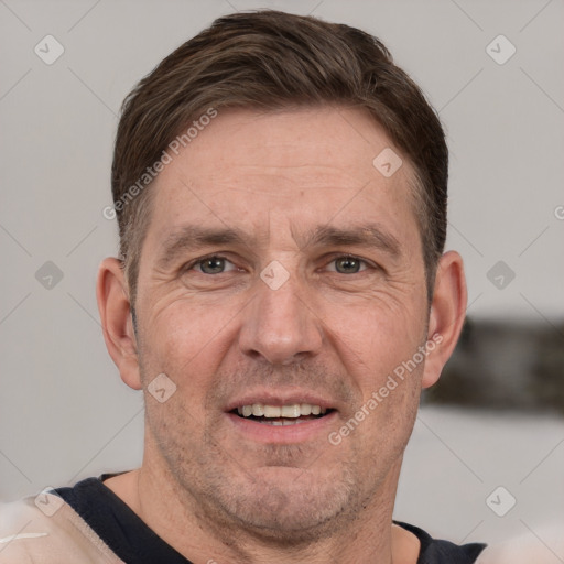 Joyful white adult male with short  brown hair and grey eyes