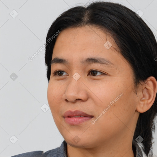 Joyful asian young-adult female with medium  black hair and brown eyes