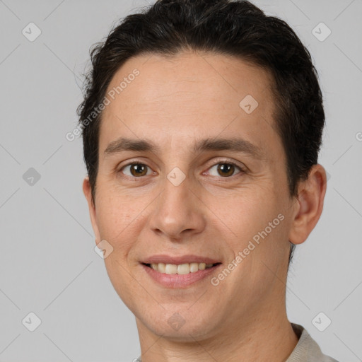 Joyful white adult male with short  brown hair and brown eyes