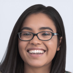 Joyful latino young-adult female with long  black hair and brown eyes