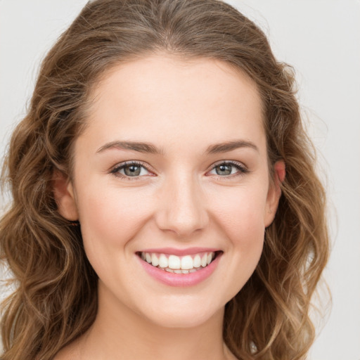 Joyful white young-adult female with long  brown hair and green eyes