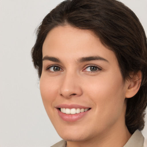 Joyful white young-adult female with medium  brown hair and brown eyes