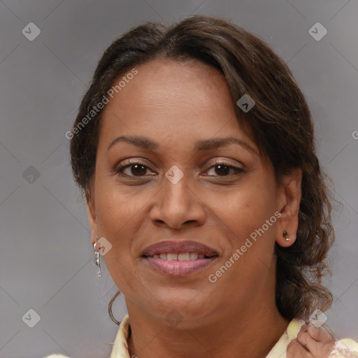 Joyful black adult female with medium  brown hair and brown eyes