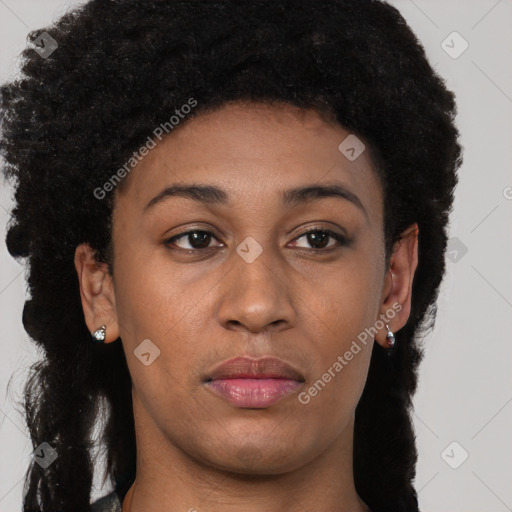 Joyful black young-adult female with long  brown hair and brown eyes