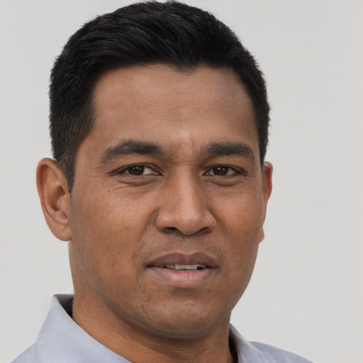Joyful asian young-adult male with short  black hair and brown eyes