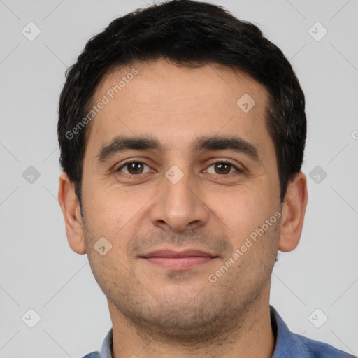 Joyful white young-adult male with short  black hair and brown eyes