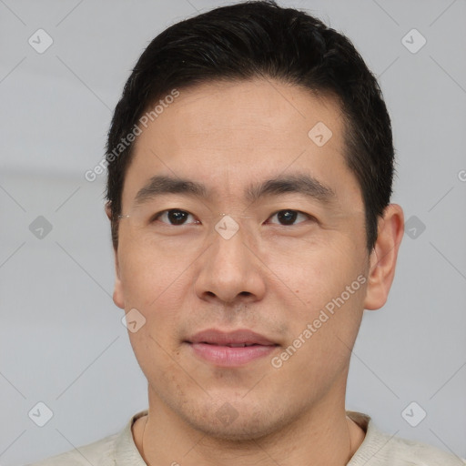 Joyful asian young-adult male with short  brown hair and brown eyes