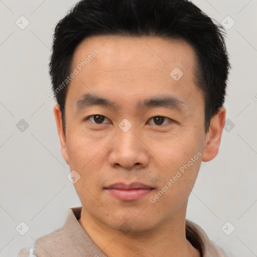 Joyful asian young-adult male with short  black hair and brown eyes