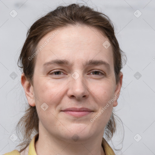 Joyful white young-adult female with medium  brown hair and grey eyes