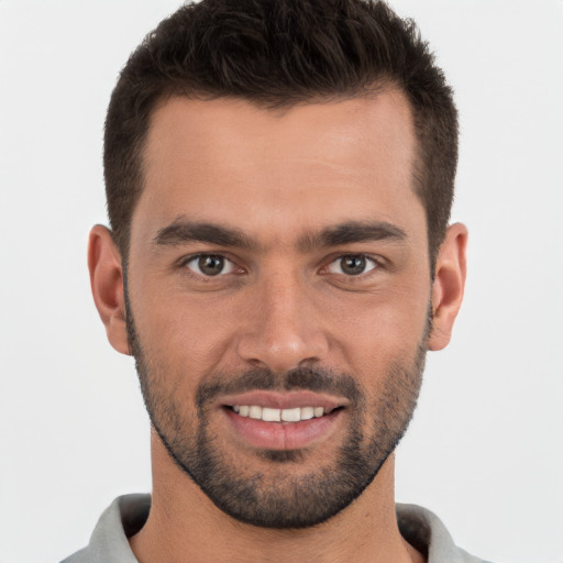 Joyful white young-adult male with short  brown hair and brown eyes