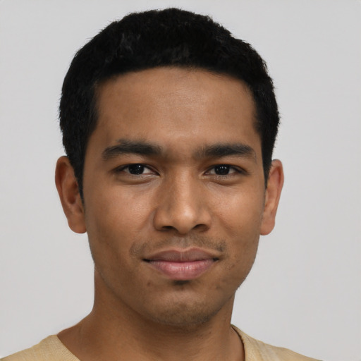 Joyful latino young-adult male with short  black hair and brown eyes