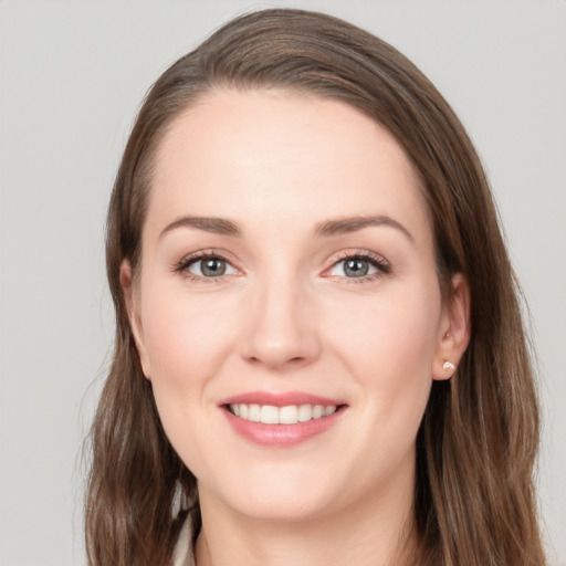 Joyful white young-adult female with long  brown hair and grey eyes