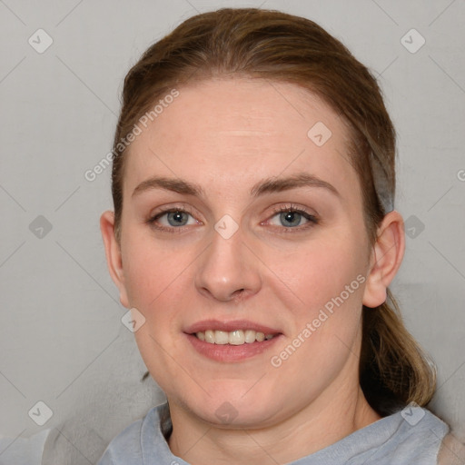 Joyful white young-adult female with short  brown hair and blue eyes