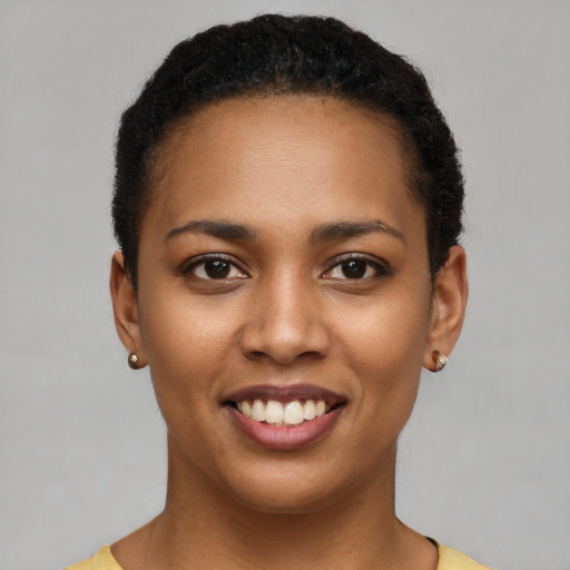 Joyful black young-adult female with short  brown hair and brown eyes