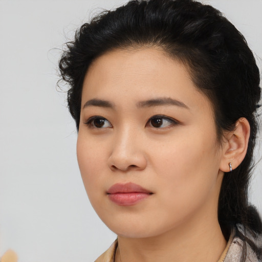 Joyful latino young-adult female with medium  black hair and brown eyes