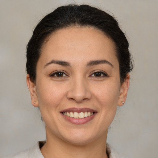 Joyful white young-adult female with medium  brown hair and brown eyes