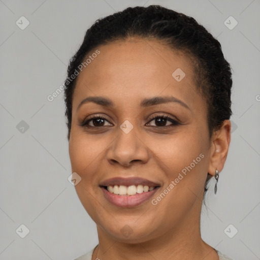 Joyful black adult female with short  brown hair and brown eyes