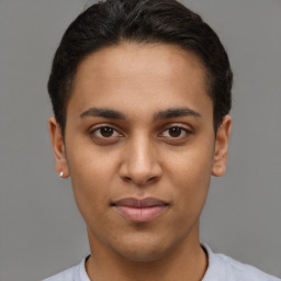 Joyful latino young-adult male with short  brown hair and brown eyes