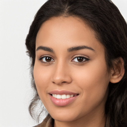 Joyful latino young-adult female with long  brown hair and brown eyes