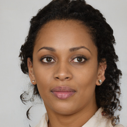 Joyful black young-adult female with medium  brown hair and brown eyes