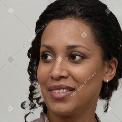 Joyful black young-adult female with medium  brown hair and brown eyes