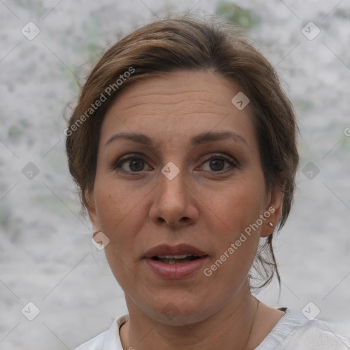 Joyful white adult female with medium  brown hair and brown eyes