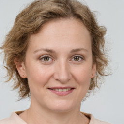 Joyful white adult female with medium  brown hair and grey eyes