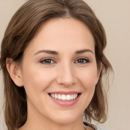 Joyful white young-adult female with medium  brown hair and brown eyes