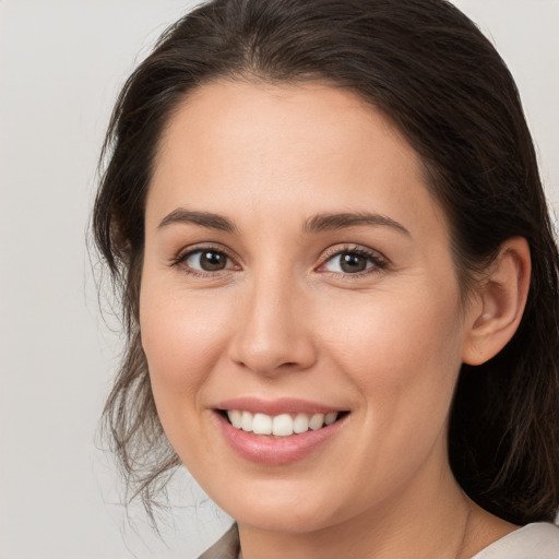 Joyful white young-adult female with medium  brown hair and brown eyes