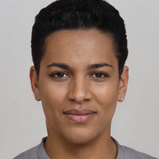 Joyful latino young-adult female with short  black hair and brown eyes