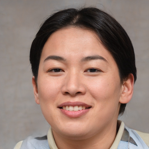 Joyful asian young-adult female with short  brown hair and brown eyes