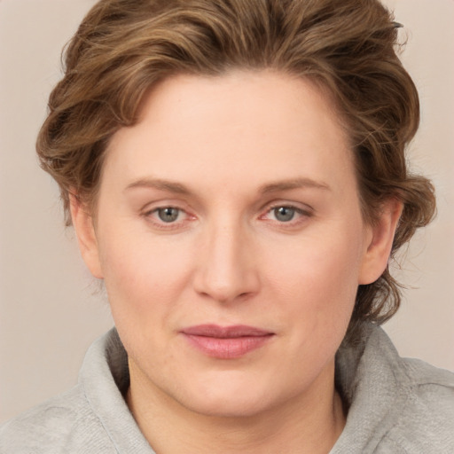 Joyful white young-adult female with medium  brown hair and blue eyes