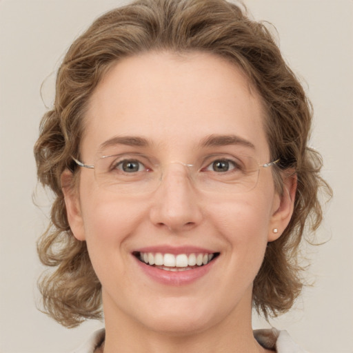 Joyful white young-adult female with medium  brown hair and green eyes