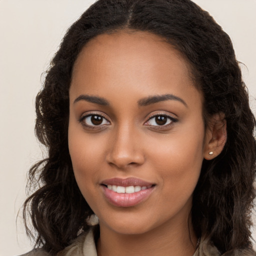 Joyful latino young-adult female with long  brown hair and brown eyes