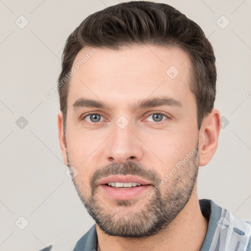 Joyful white young-adult male with short  brown hair and brown eyes