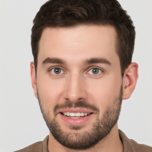 Joyful white young-adult male with short  brown hair and brown eyes