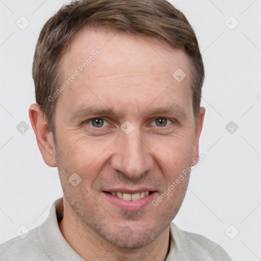 Joyful white adult male with short  brown hair and grey eyes