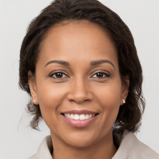 Joyful latino young-adult female with medium  brown hair and brown eyes